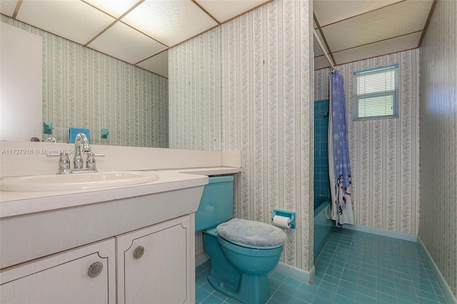 full bathroom featuring a paneled ceiling, shower / bath combo, tile patterned flooring, vanity, and toilet