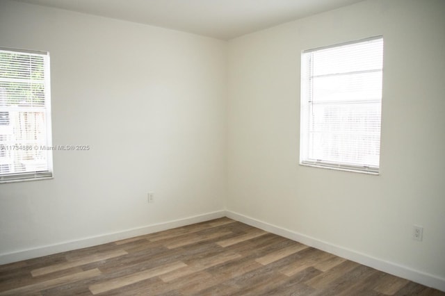 unfurnished room featuring dark hardwood / wood-style floors