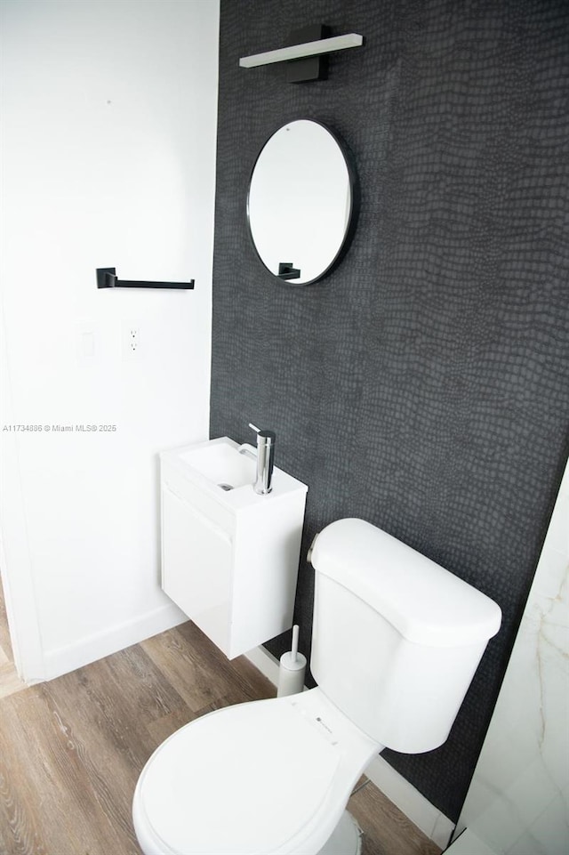 bathroom featuring vanity, toilet, and hardwood / wood-style floors