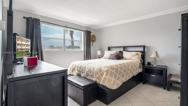 bedroom with light tile patterned flooring, crown molding, and a textured ceiling