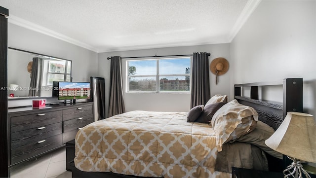 bedroom featuring light tile patterned floors, crown molding, and a textured ceiling