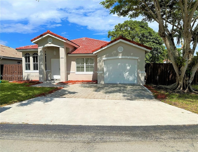 mediterranean / spanish home with a garage