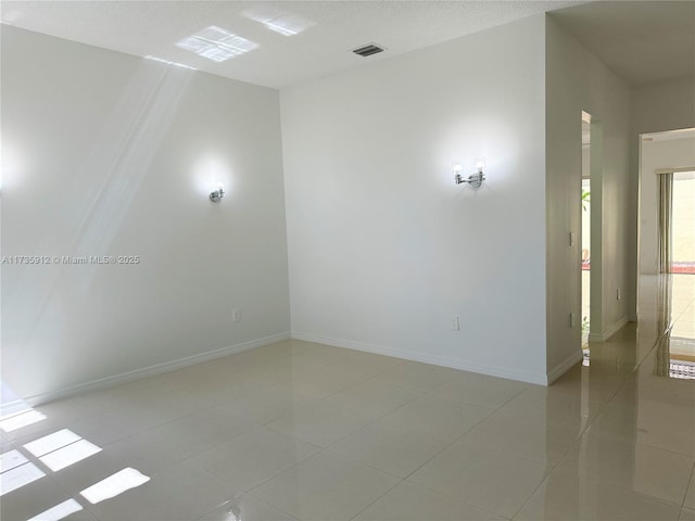 unfurnished room with light tile patterned floors