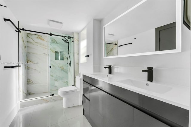 bathroom featuring a shower with door, vanity, and toilet