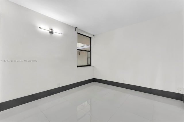 empty room with light tile patterned floors