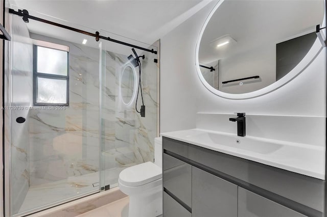 bathroom with a shower with door, vanity, and toilet