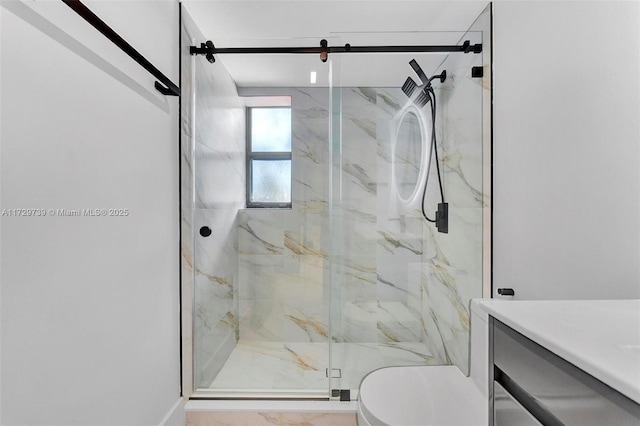 bathroom with a shower with shower door and toilet