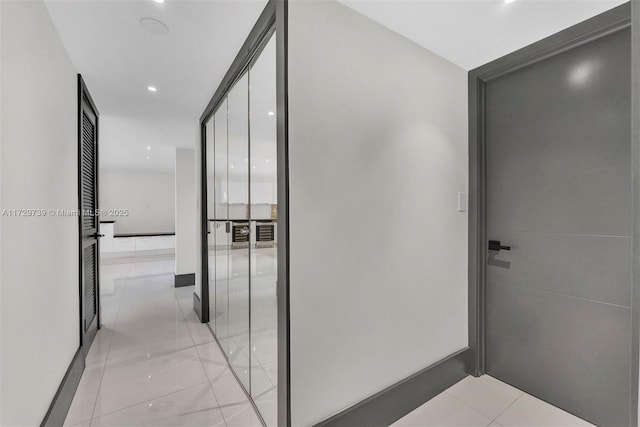 hall featuring light tile patterned flooring