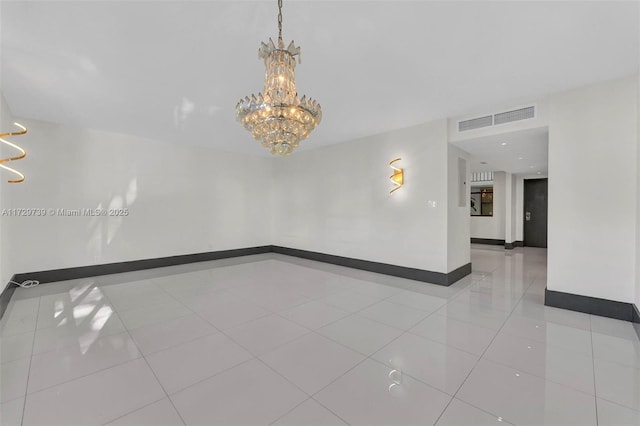 tiled empty room with a chandelier