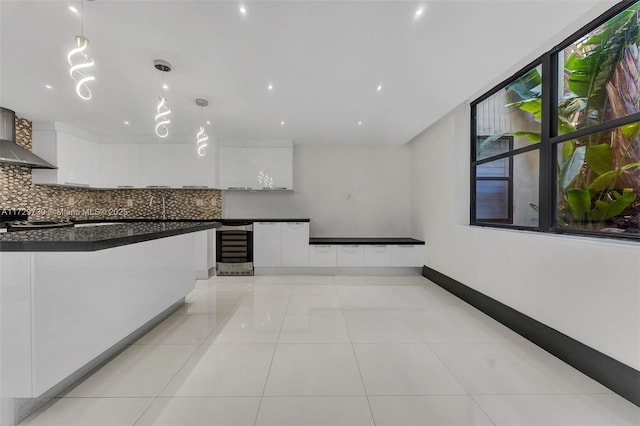 kitchen with tasteful backsplash, pendant lighting, white cabinets, and light tile patterned floors