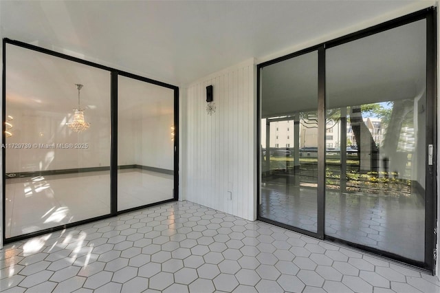 tiled spare room with expansive windows