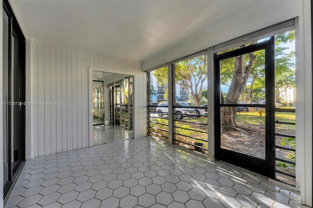 unfurnished sunroom with plenty of natural light