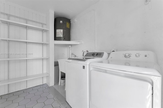 laundry room with separate washer and dryer and dark tile patterned flooring