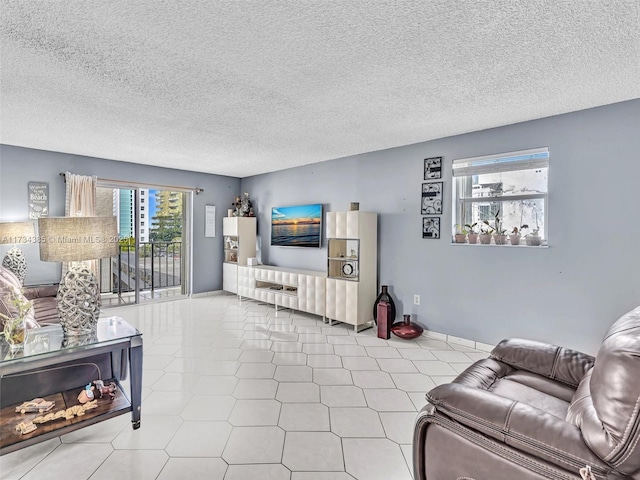 living room featuring a textured ceiling and light tile patterned flooring