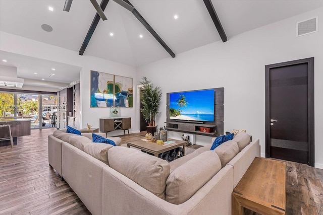 living room with high vaulted ceiling, hardwood / wood-style floors, and beam ceiling