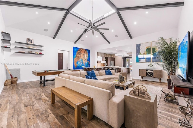 living room with hardwood / wood-style flooring, billiards, high vaulted ceiling, and beam ceiling