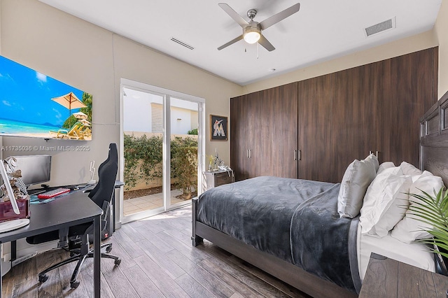 bedroom featuring light hardwood / wood-style flooring, ceiling fan, and access to exterior