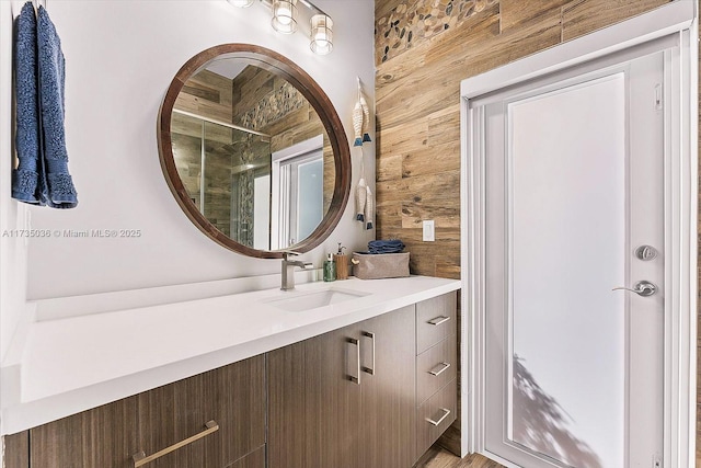 bathroom featuring vanity and wooden walls