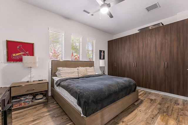 bedroom with wood-type flooring and ceiling fan