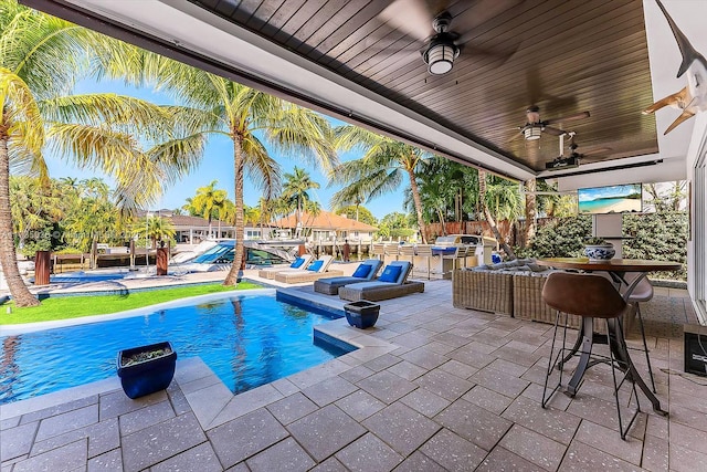 view of pool with a hot tub, a patio, and ceiling fan