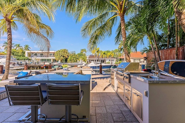 view of patio with a wet bar and exterior kitchen