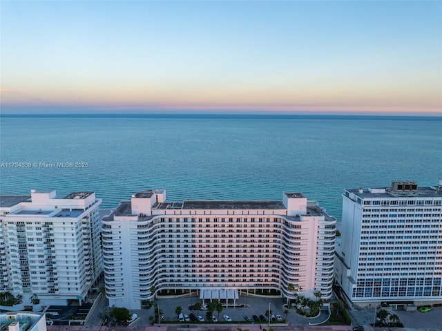 aerial view at dusk with a water view