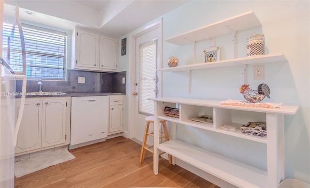 580 Egret Dr Unit 119, Hallandale Beach, FL 33009 - kitchen featuring open shelves, light wood-style floors, tasteful backsplash, a sink, and dishwasher