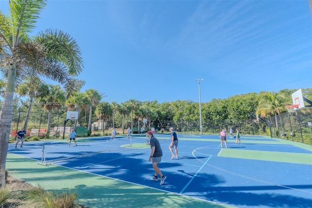 view of sport court with basketball hoop