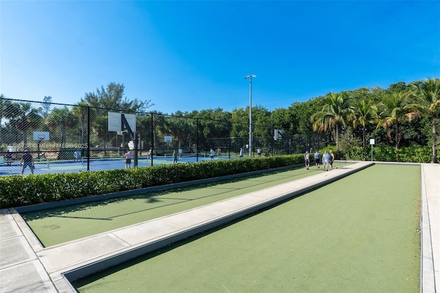 view of home's community with tennis court