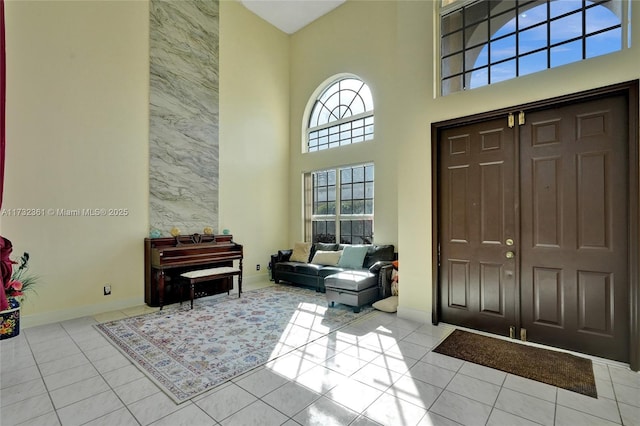 tiled foyer entrance featuring a high ceiling