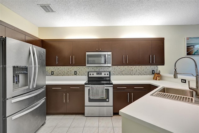 kitchen with sink, dark brown cabinets, and appliances with stainless steel finishes