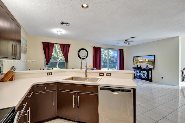 kitchen featuring sink, dark brown cabinets, kitchen peninsula, and appliances with stainless steel finishes