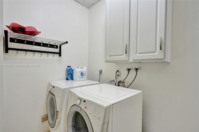 washroom featuring separate washer and dryer and cabinets