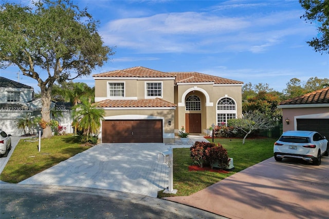 mediterranean / spanish-style house featuring a garage and a front lawn