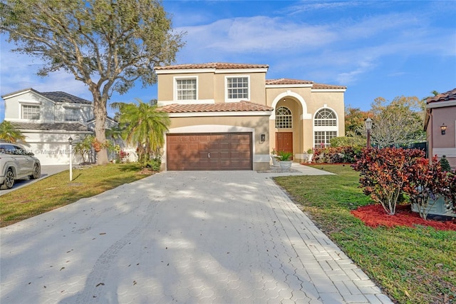 mediterranean / spanish home with a garage and a front yard