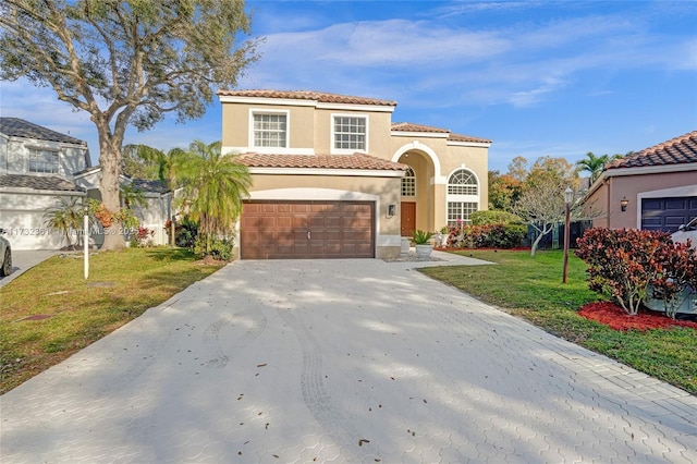 mediterranean / spanish home with a garage and a front yard