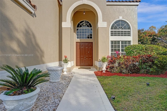 doorway to property with a yard