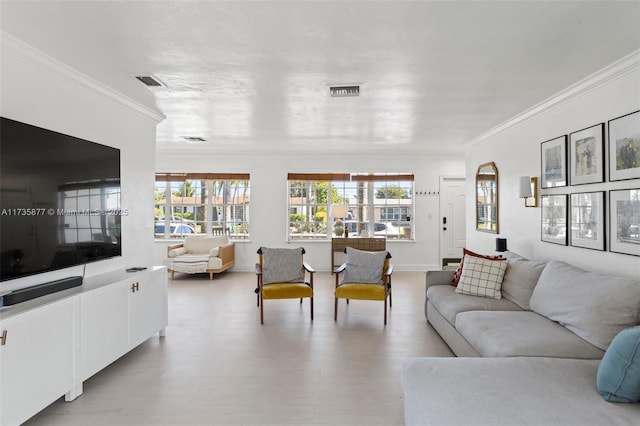 living room with crown molding and light wood-type flooring