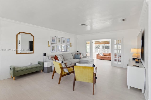 living room with crown molding and light hardwood / wood-style floors