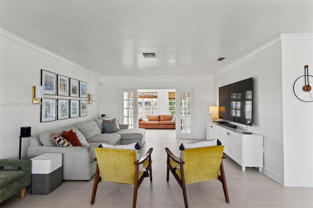 living room featuring ornamental molding, french doors, and light wood-type flooring