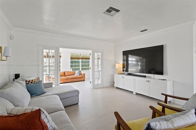 living room featuring ornamental molding and light hardwood / wood-style floors