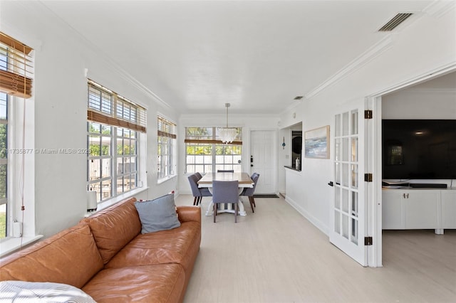 living room with crown molding and light wood-type flooring