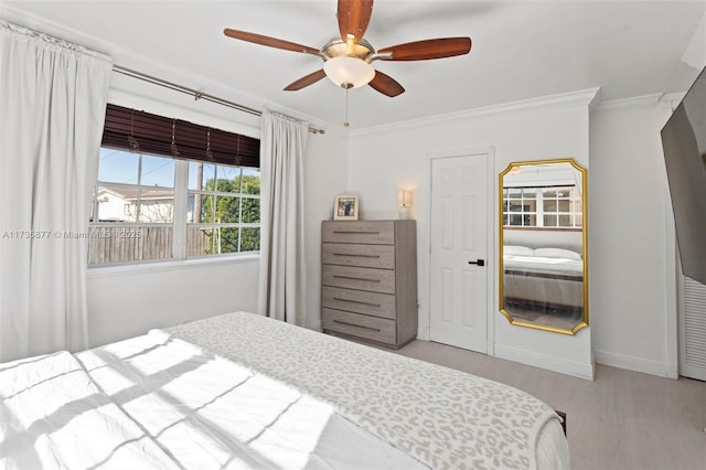 bedroom with crown molding, ceiling fan, and light wood-type flooring