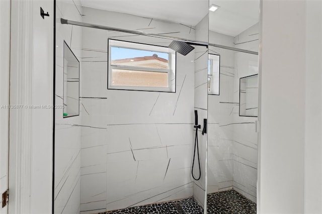 bathroom featuring a tile shower