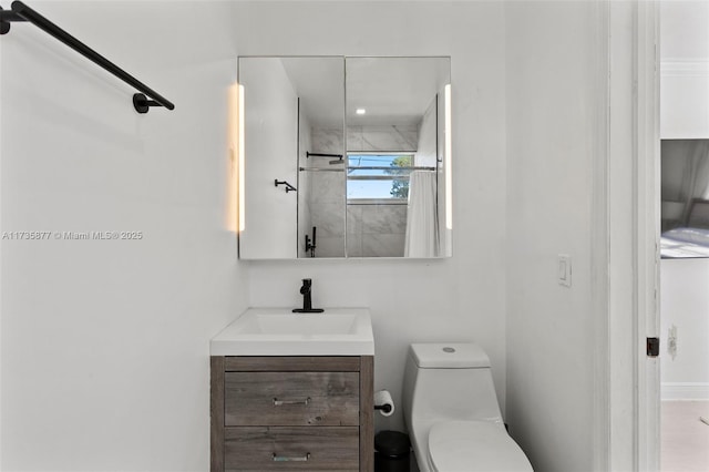 bathroom with vanity, toilet, and a tile shower