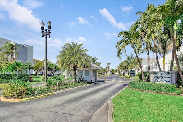1605 S US Highway 1 Unit M1 # 106, Jupiter, FL 33477 - view of asphalt street with street lighting, curbs, a residential view, and a gated entry