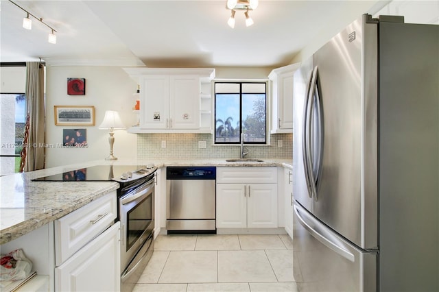 1605 S US Highway 1 Unit M1 # 106, Jupiter, FL 33477 - kitchen with appliances with stainless steel finishes, open shelves, a sink, backsplash, and white cabinets