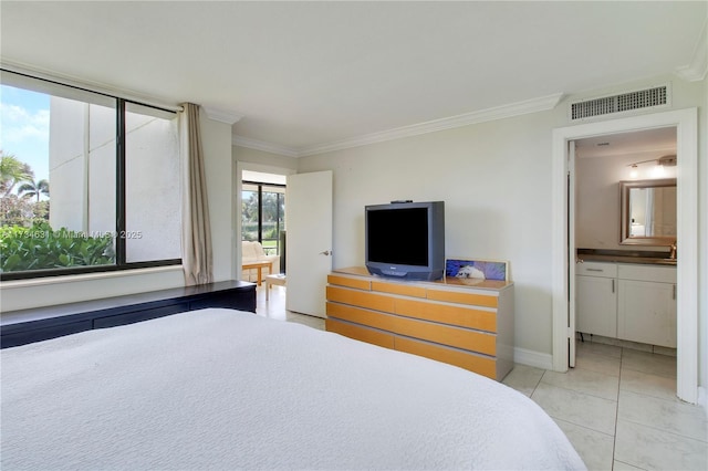 tiled bedroom with connected bathroom and ornamental molding