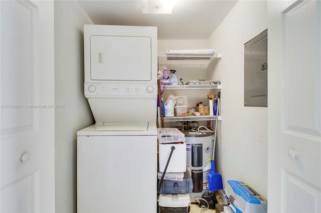 laundry room with stacked washer / drying machine, electric panel, and water heater