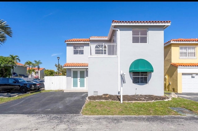 mediterranean / spanish-style home with french doors